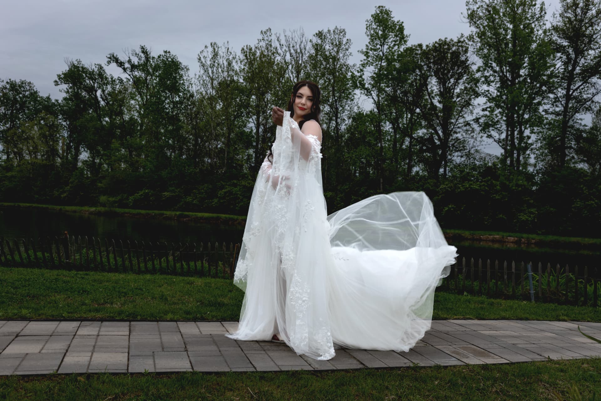 Maddie holding her dress out for an outdoor portrait