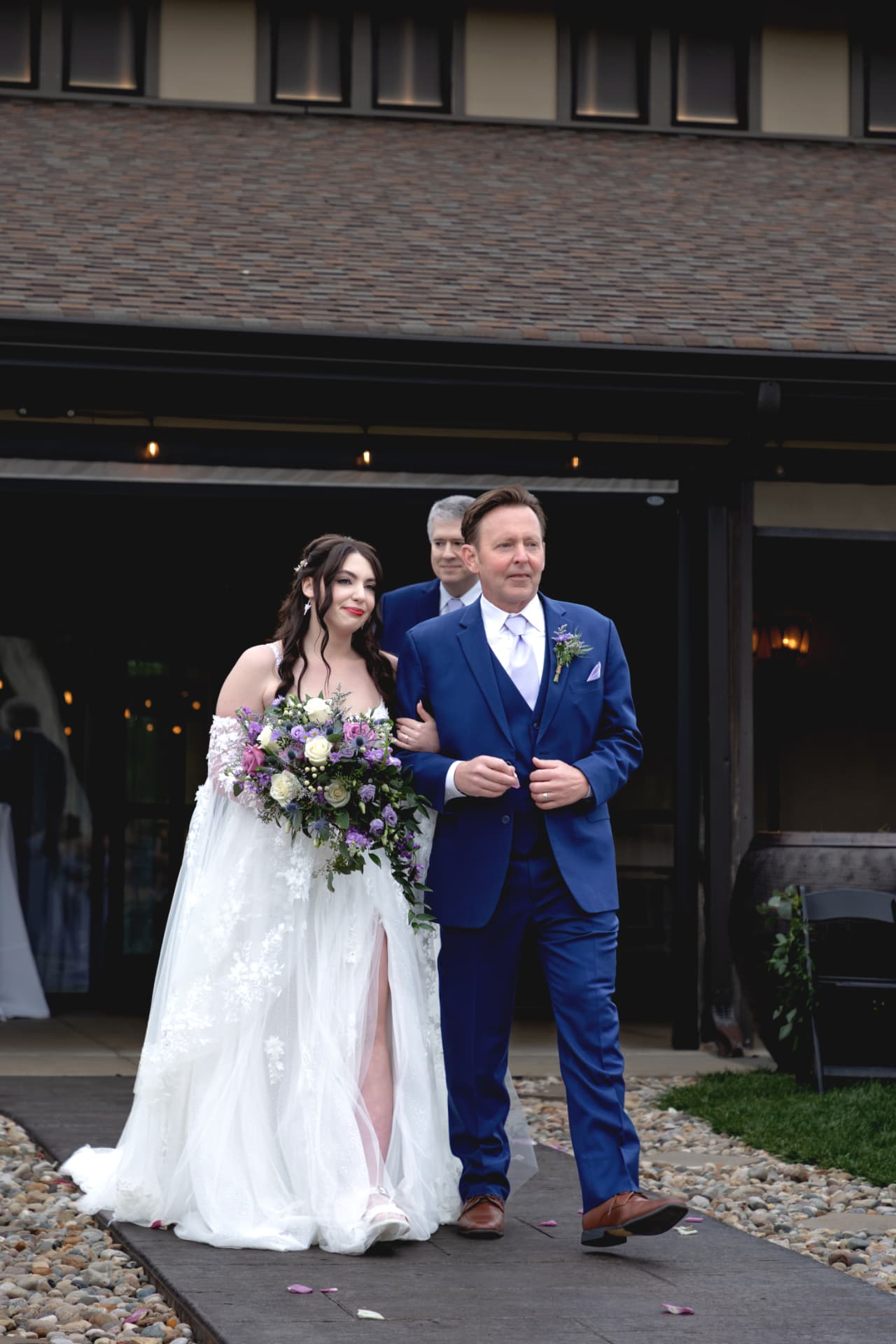 Maddie walking with her father toward the ceremony