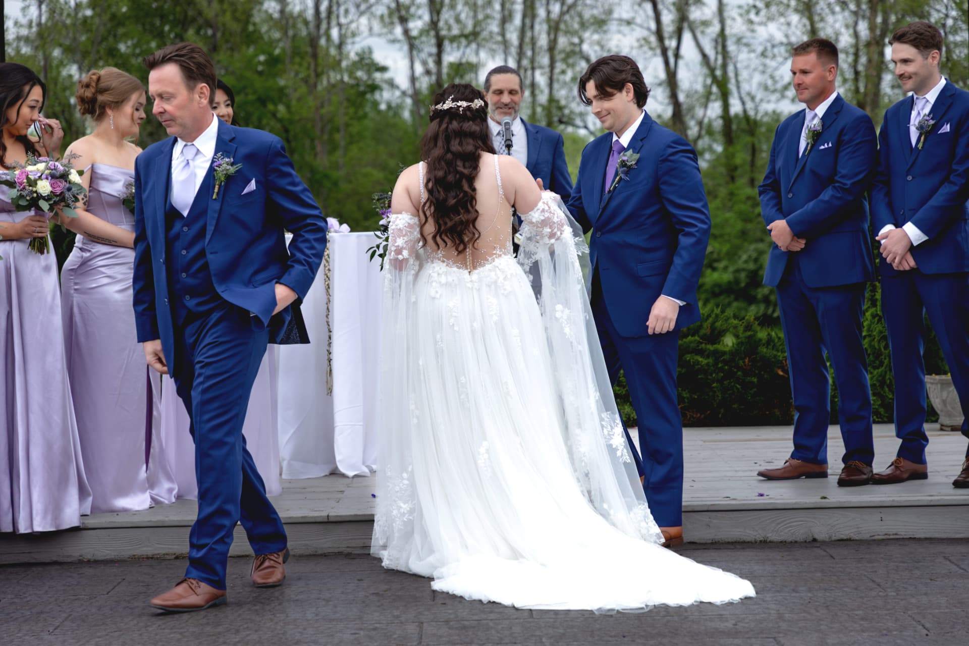 Tristan and Maddie with their wedding party beneath the pavilion