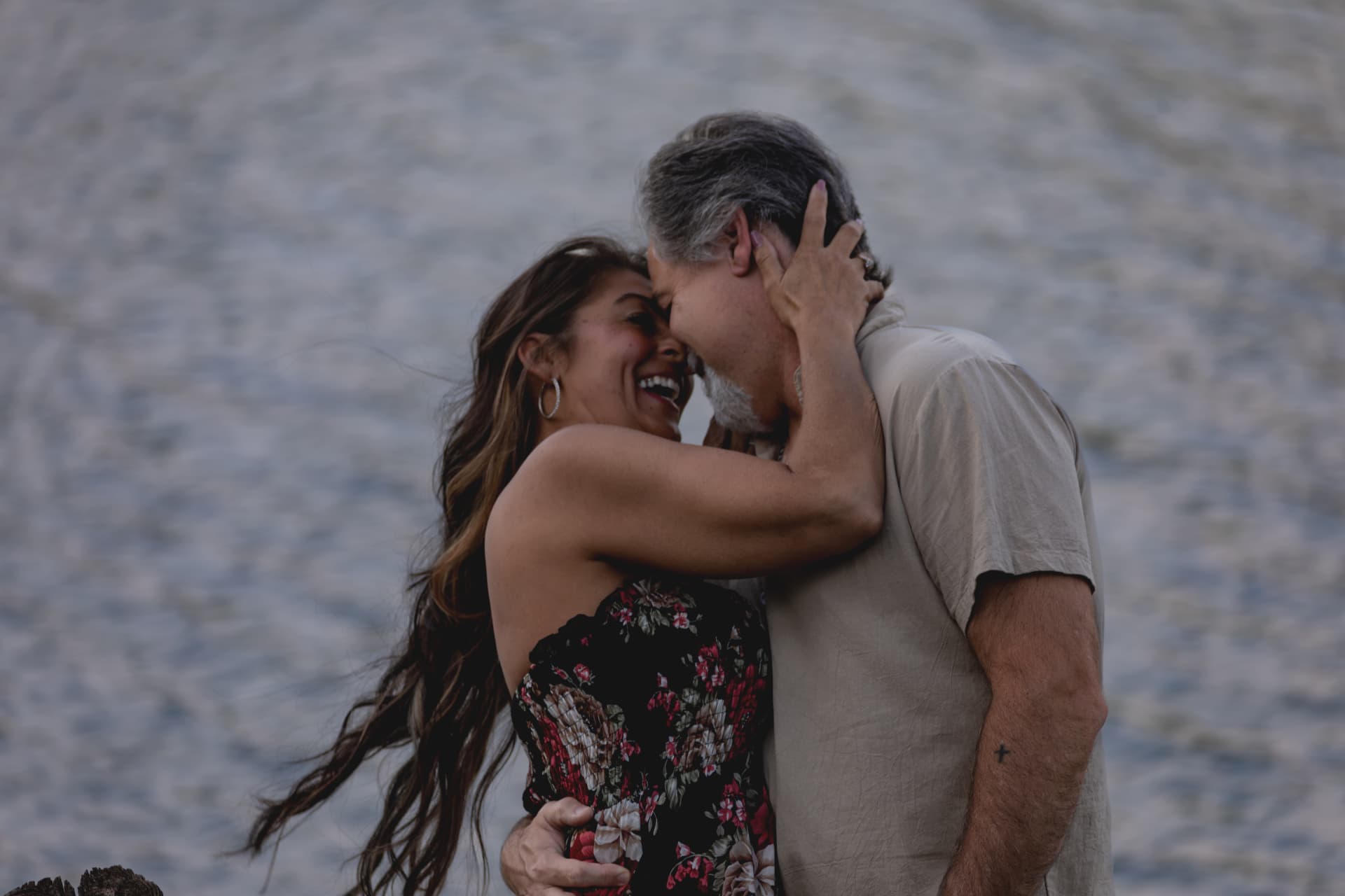 Couple laughing together by the water