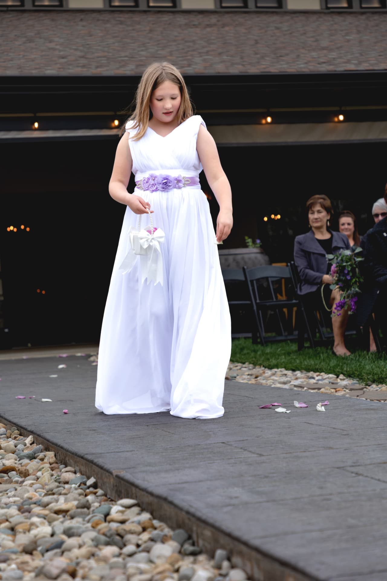 A young attendant walking toward the ceremony
