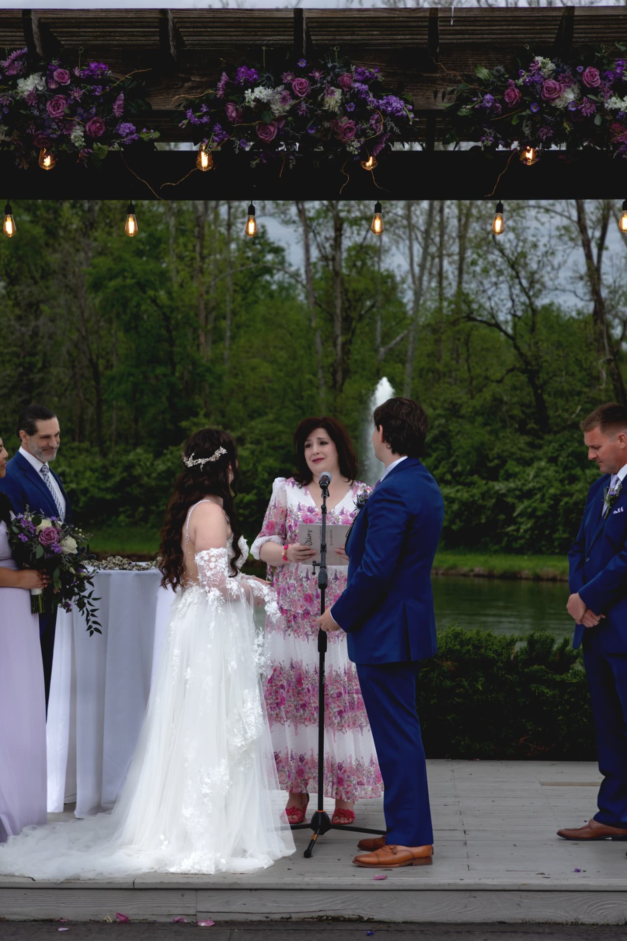 Tristan and Maddie standing together during the outdoor ceremony