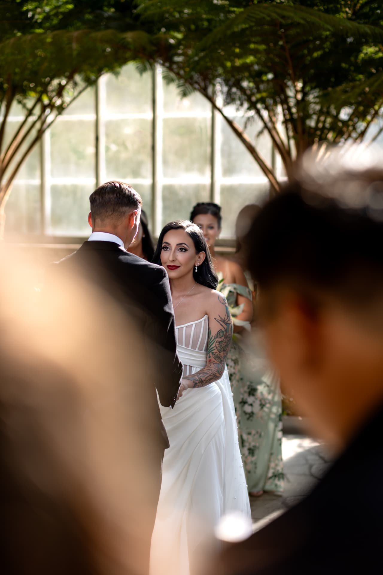 Bride with tattooed arm during her wedding ceremony