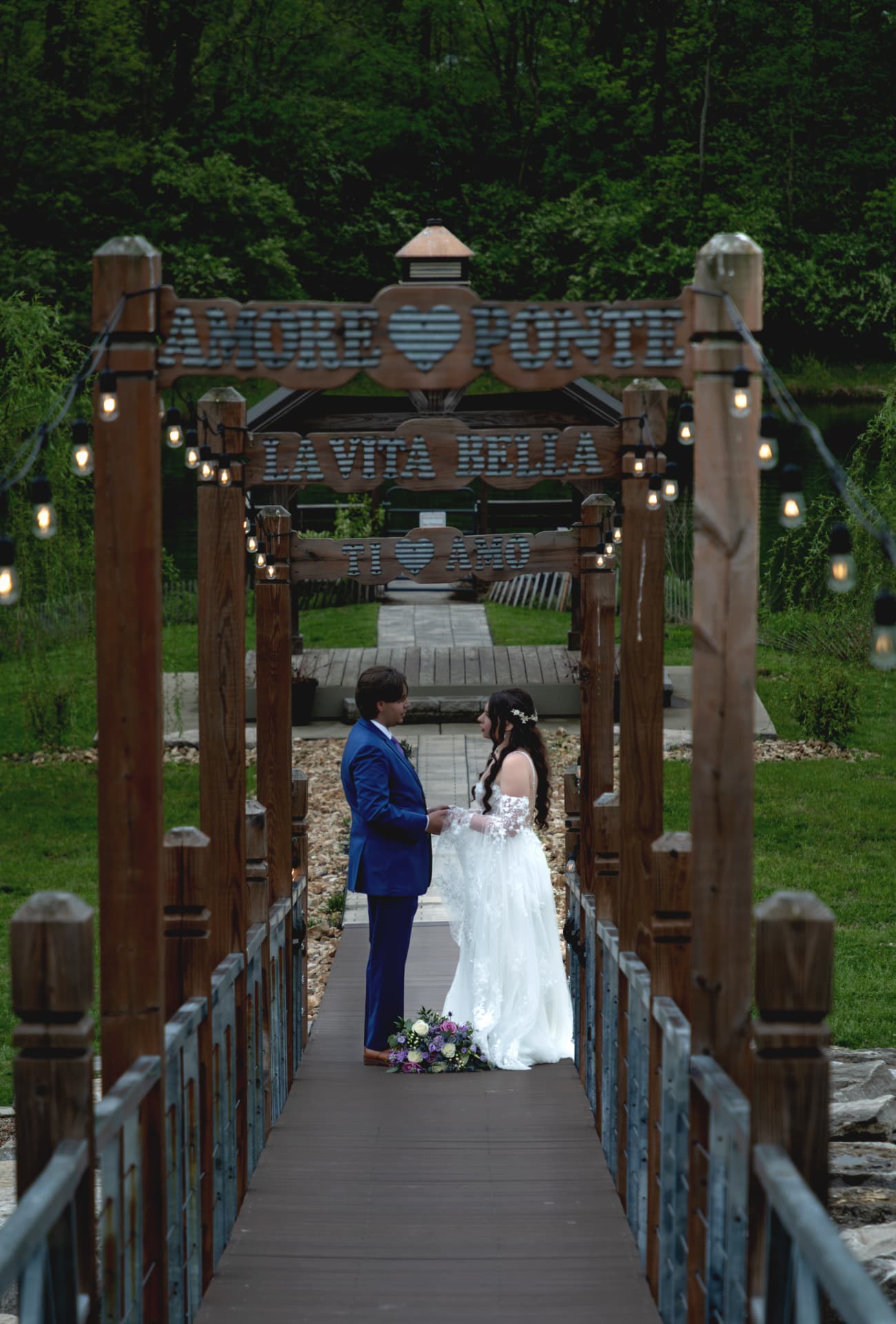 Tristan and Maddie standing on a wooden bridge
