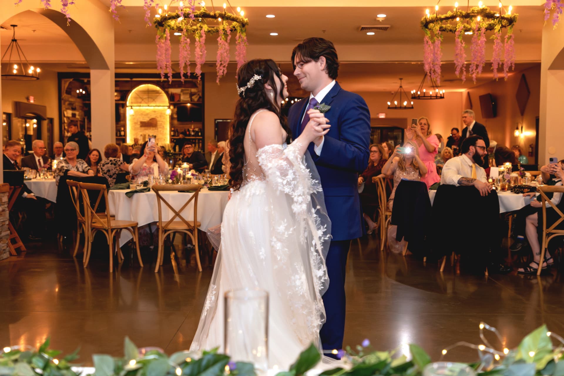 Tristan and Maddie sharing their first dance surrounded by guests