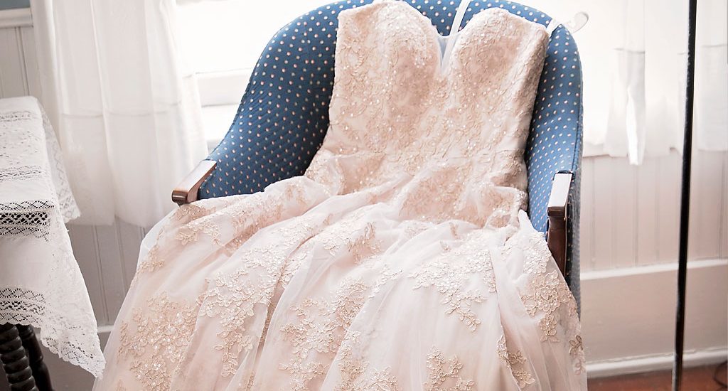 wedding dress on chair by window