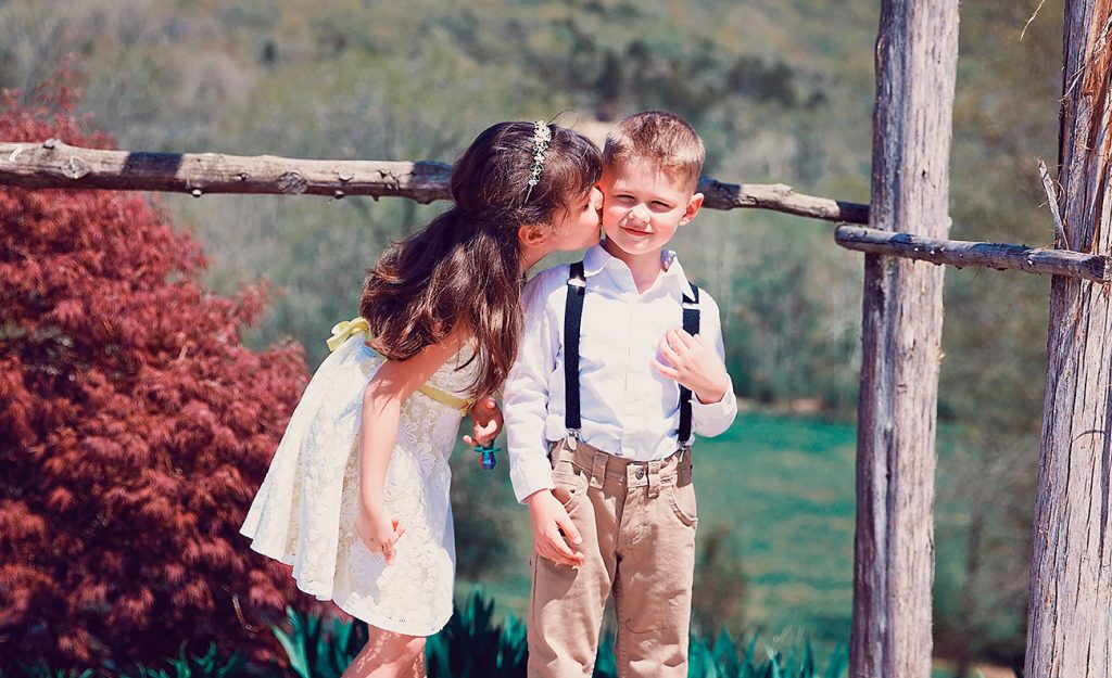 Little girl kissing a boy