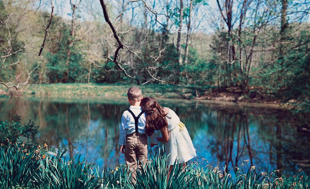 Your girl leaning on shoulder of boy looking at a lake